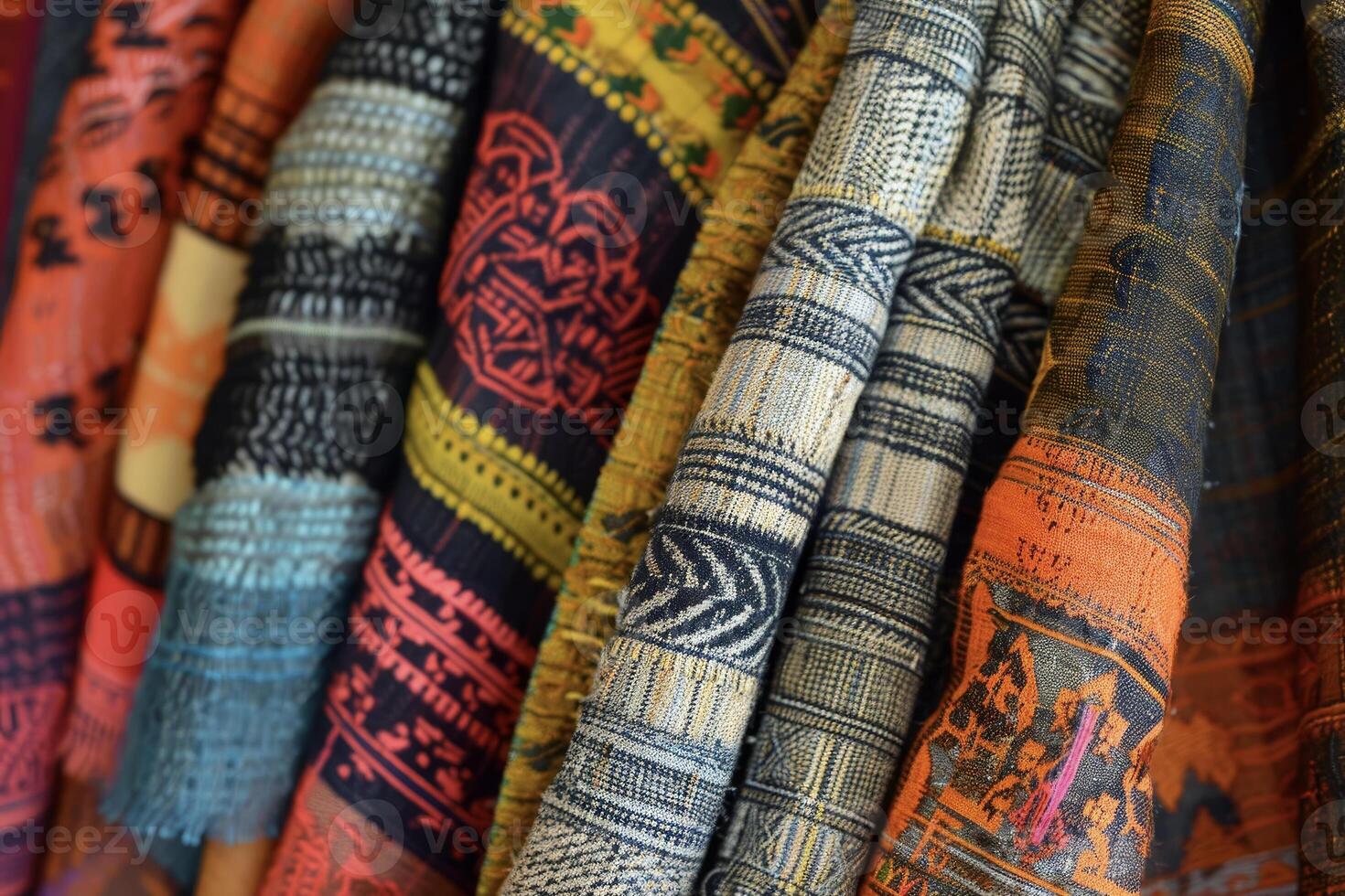 A row of colorful scarves hanging on a rack photo