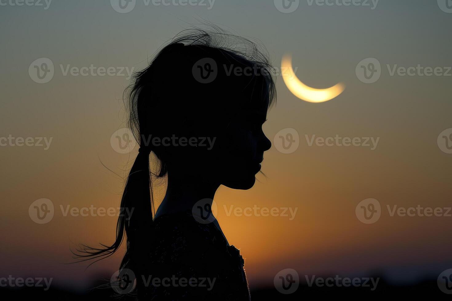 Silhouette of a girl with a crescent moon in the background photo