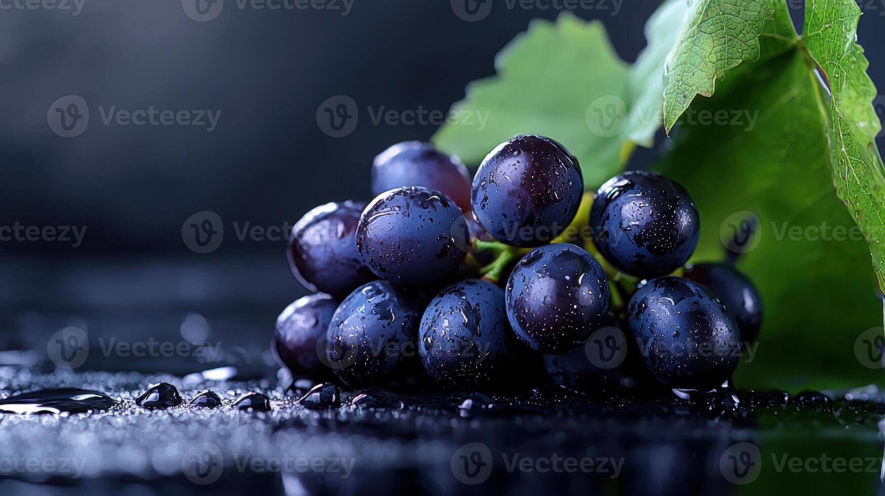Grapes on a black background with water drops photo