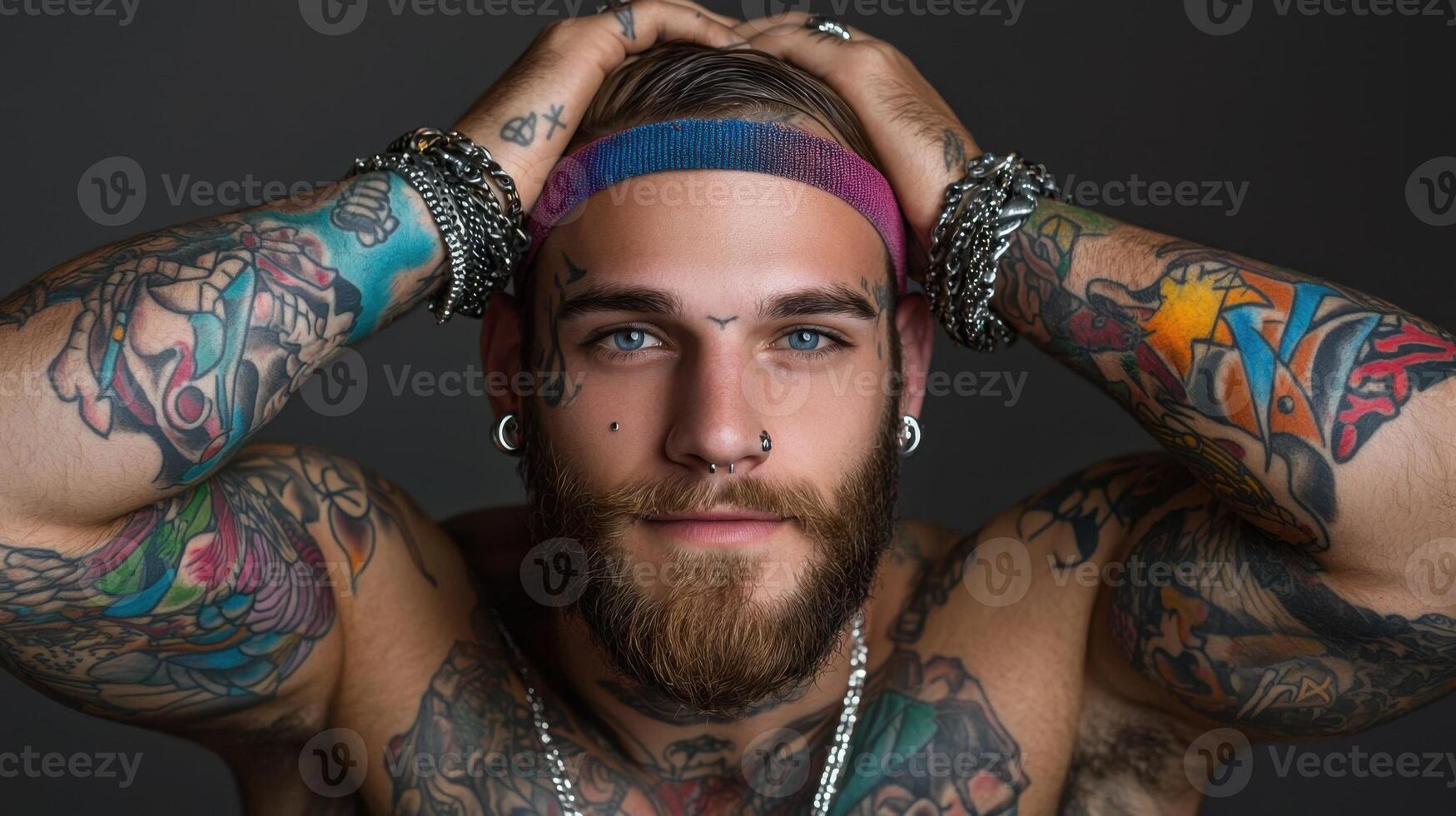 A man with tattoos on his arms and chest photo