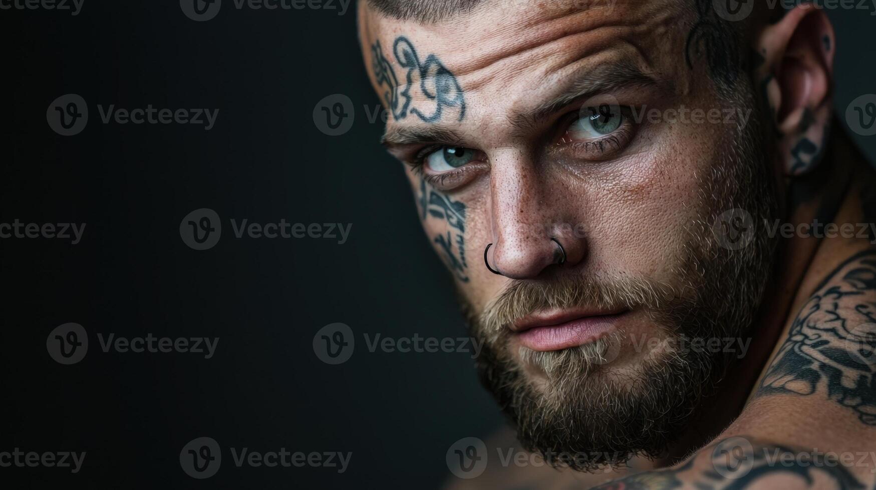 A man with tattoos on his face and chest photo