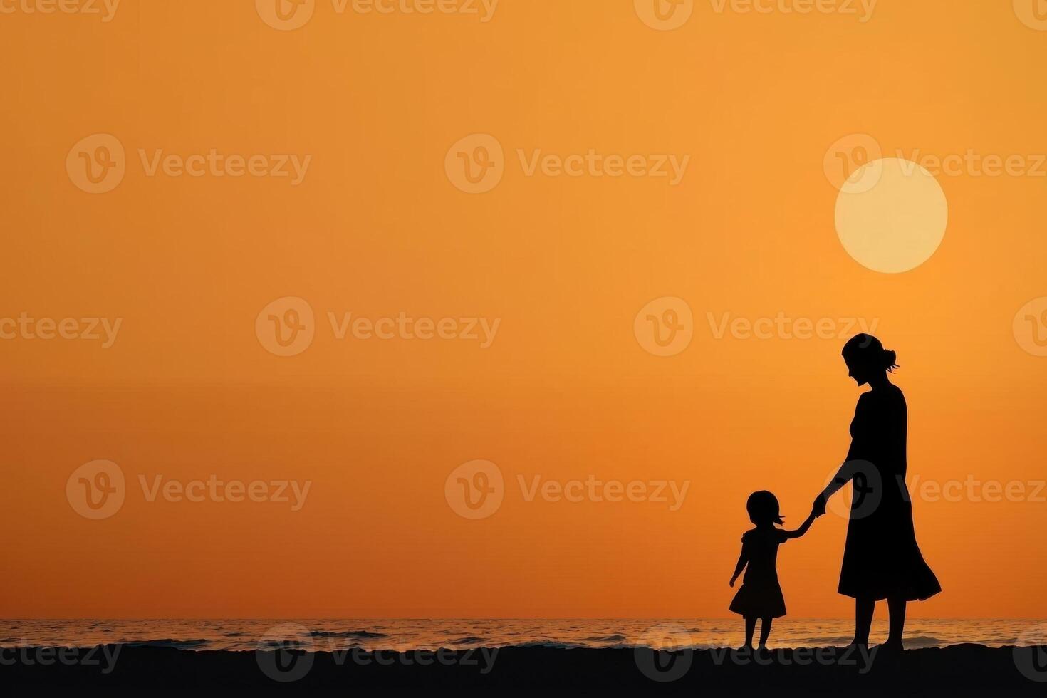 Silhouette of a mother and child on the beach at sunset photo