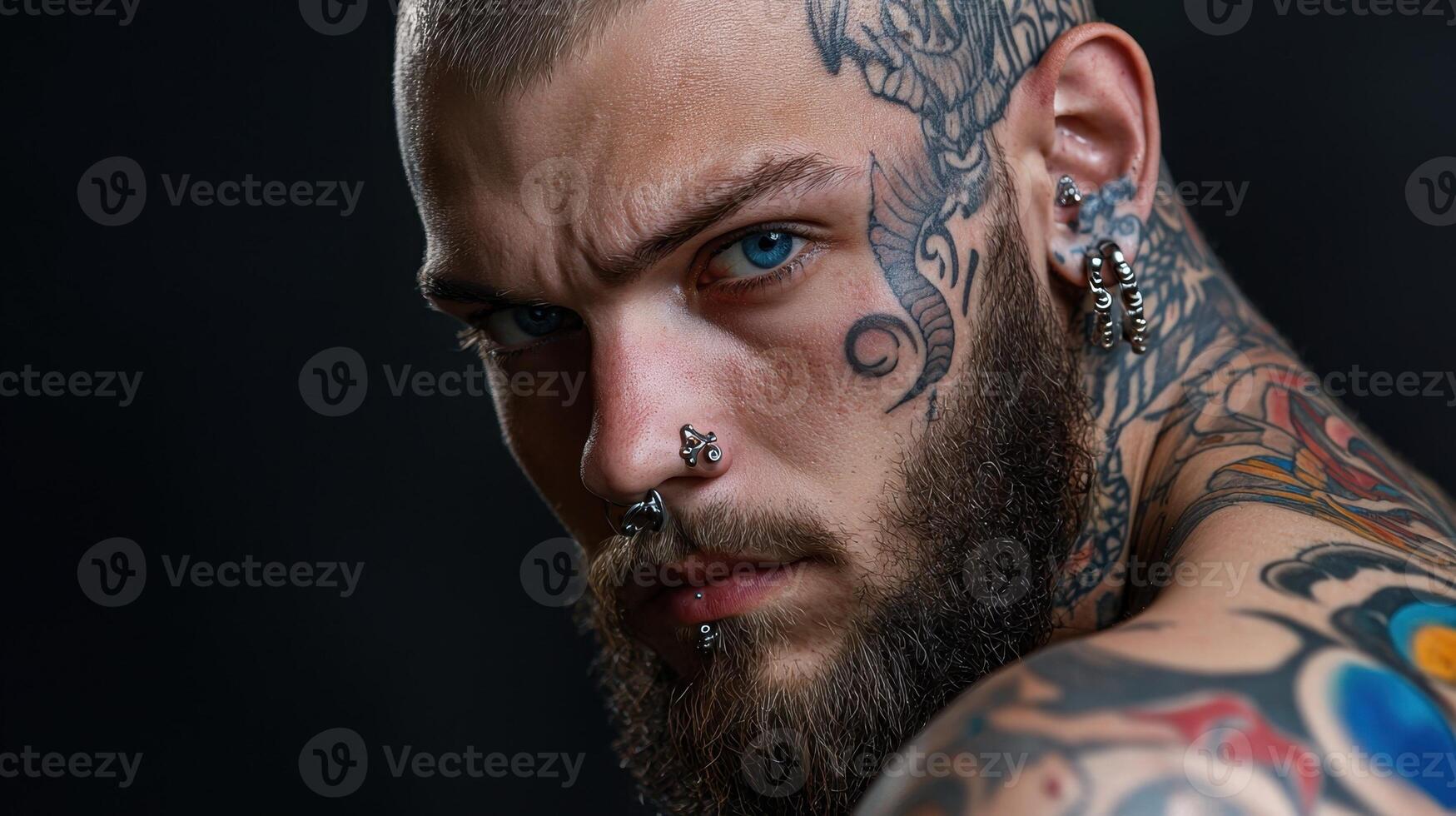 A man with tattoos on his face and chest photo