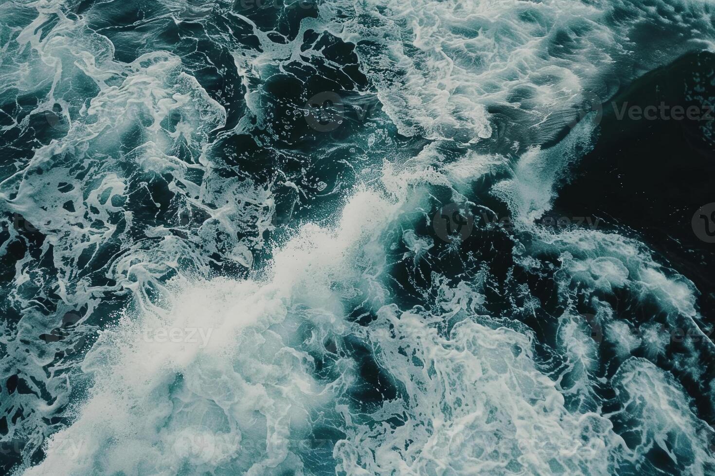 The ocean is full of white foam and waves photo