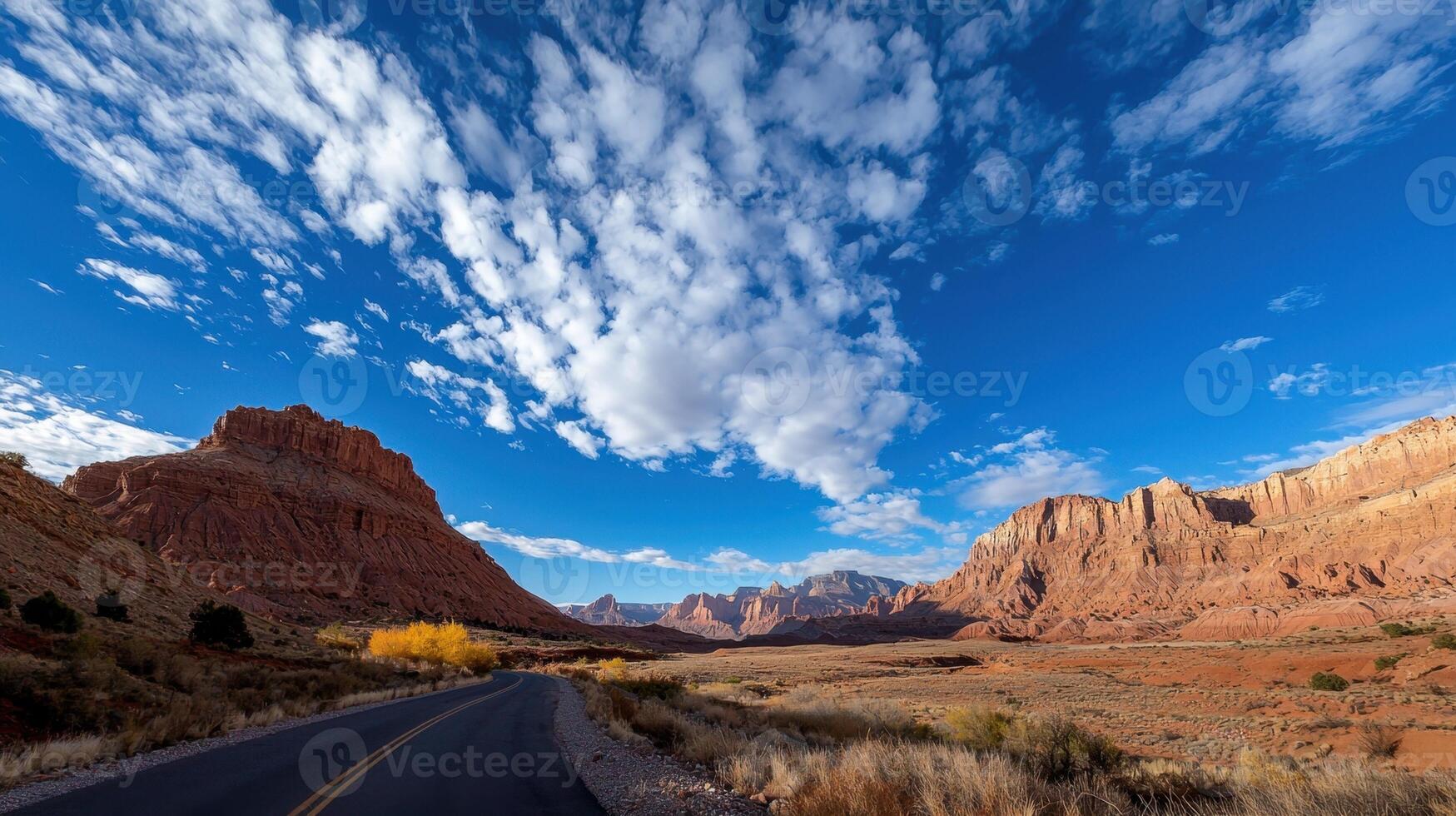 A road in the desert with clouds in the sky photo