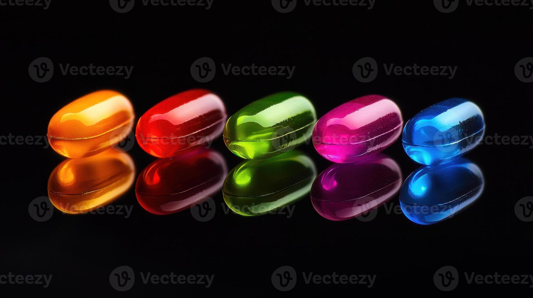 A row of colorful pills on a black surface photo