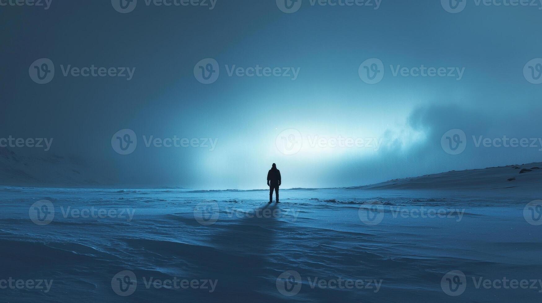 A person standing in the middle of a snowy field photo