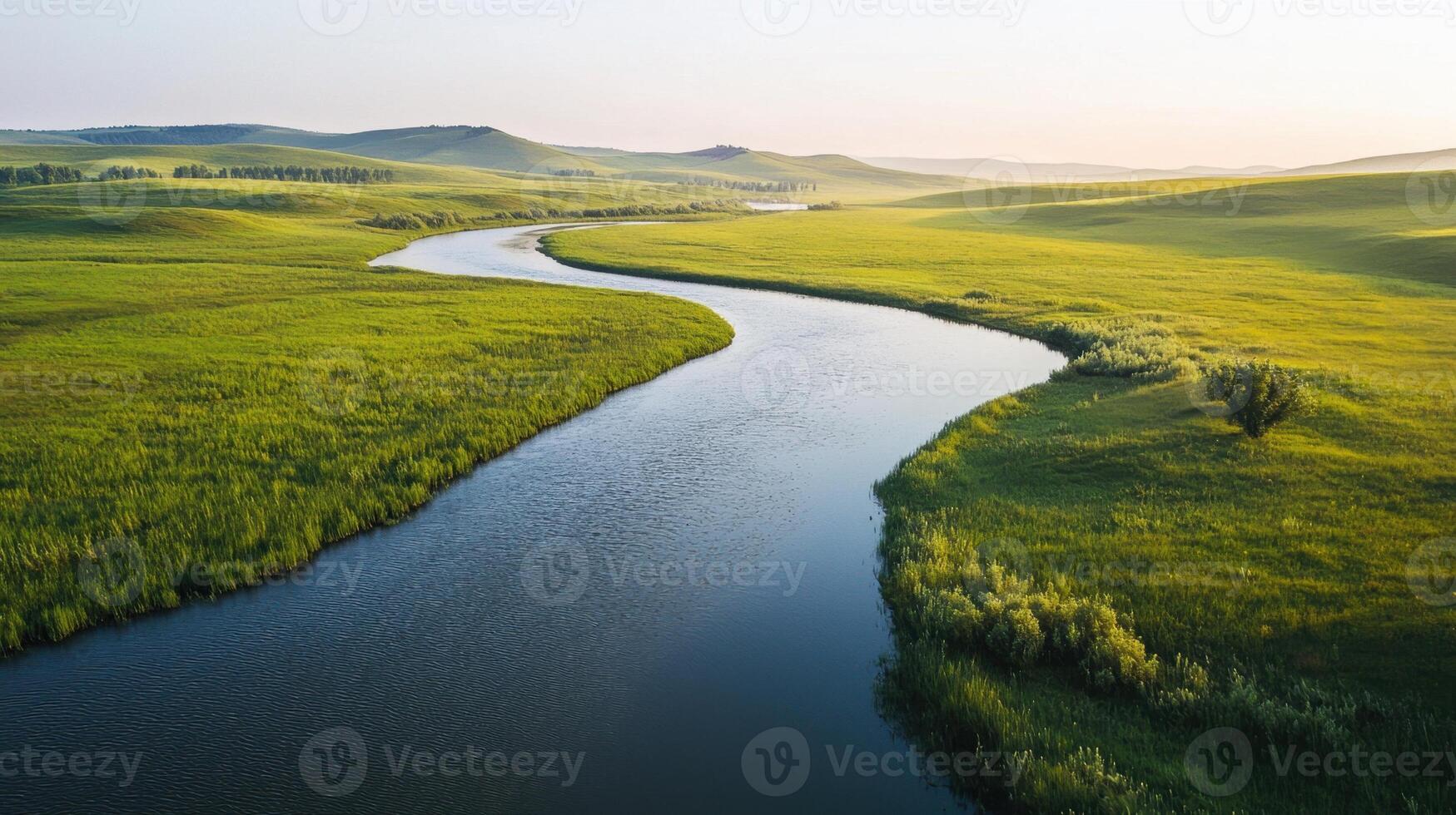 A river runs through a green field photo