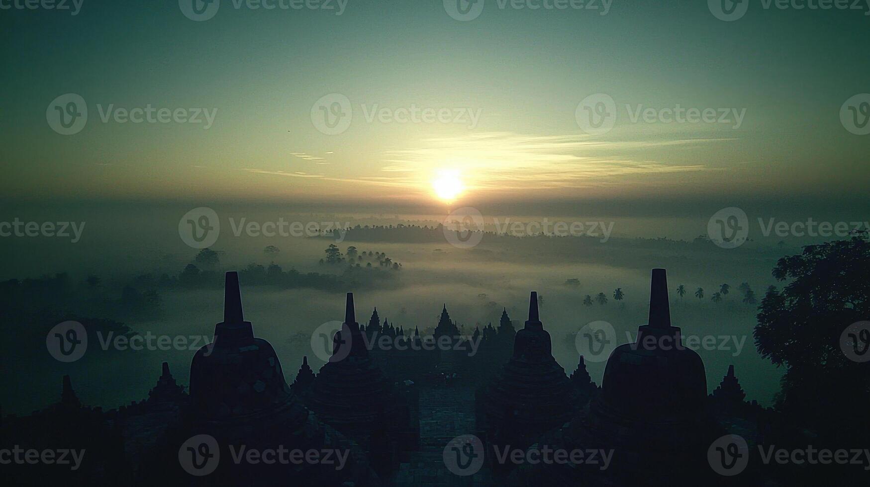The sun rises over the foggy landscape of bagan, myanmar photo