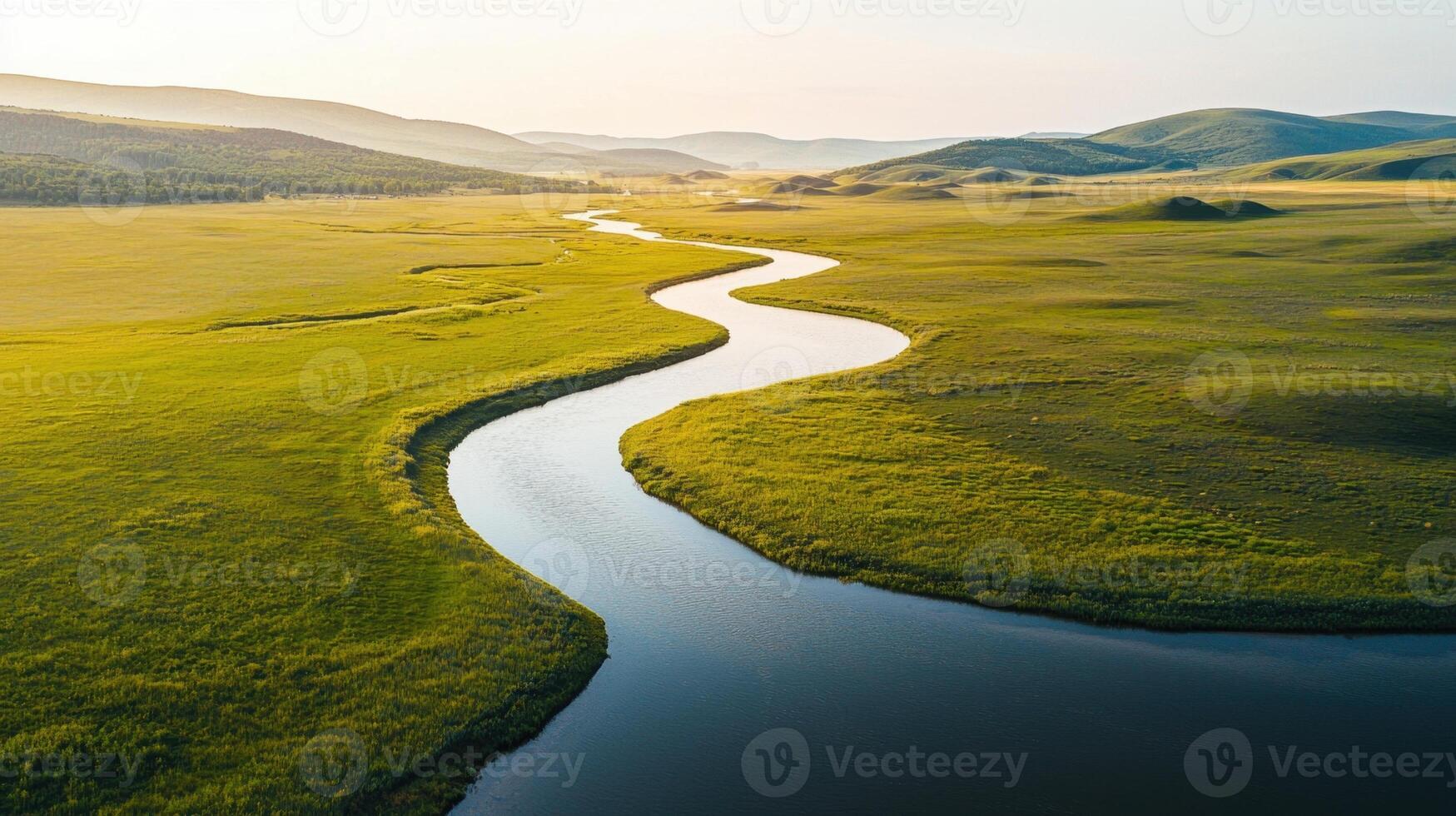 A river flowing through a grassy field photo