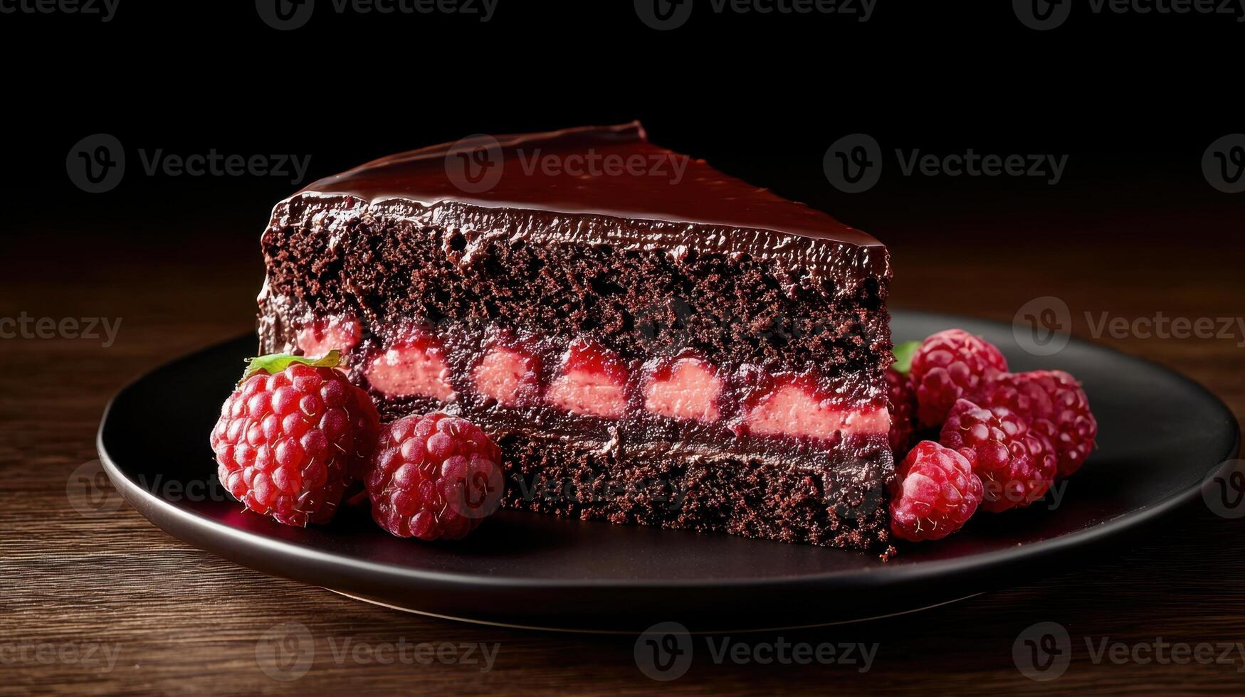 A piece of chocolate cake with raspberries on top photo