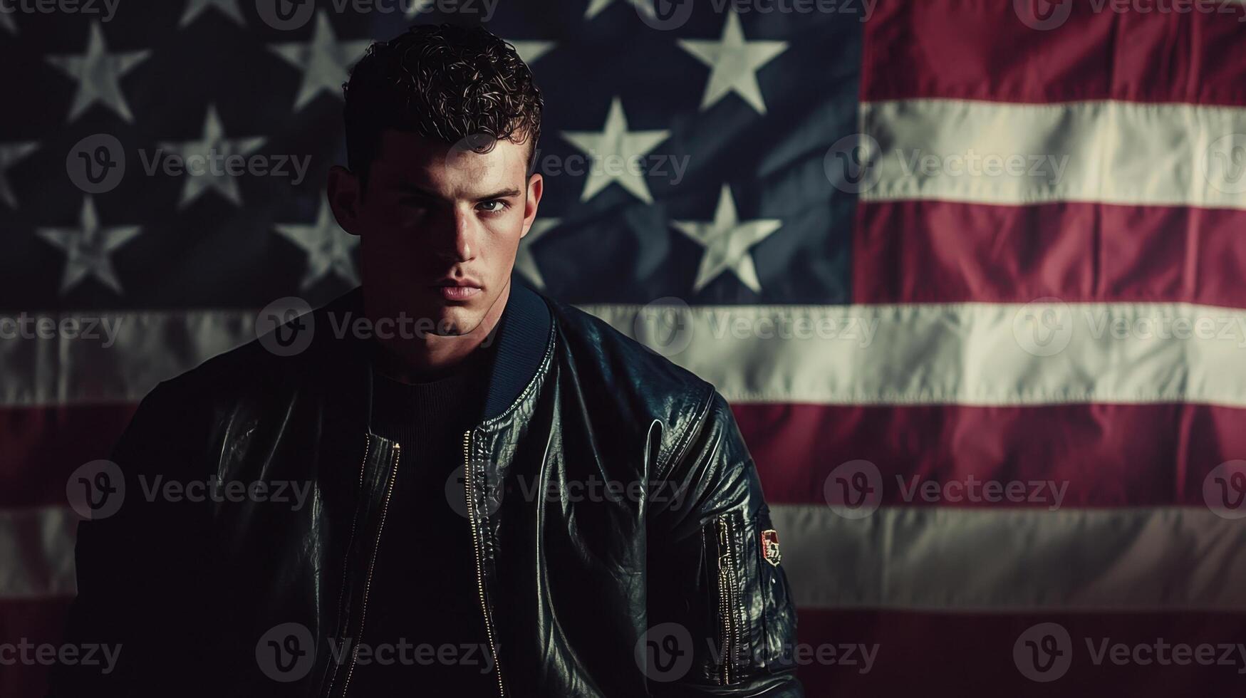 A man in a leather jacket standing in front of an american flag photo