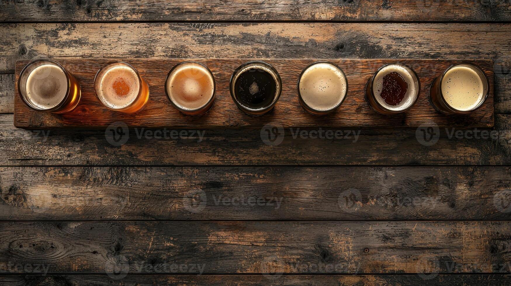 A row of beer glasses on a wooden table photo
