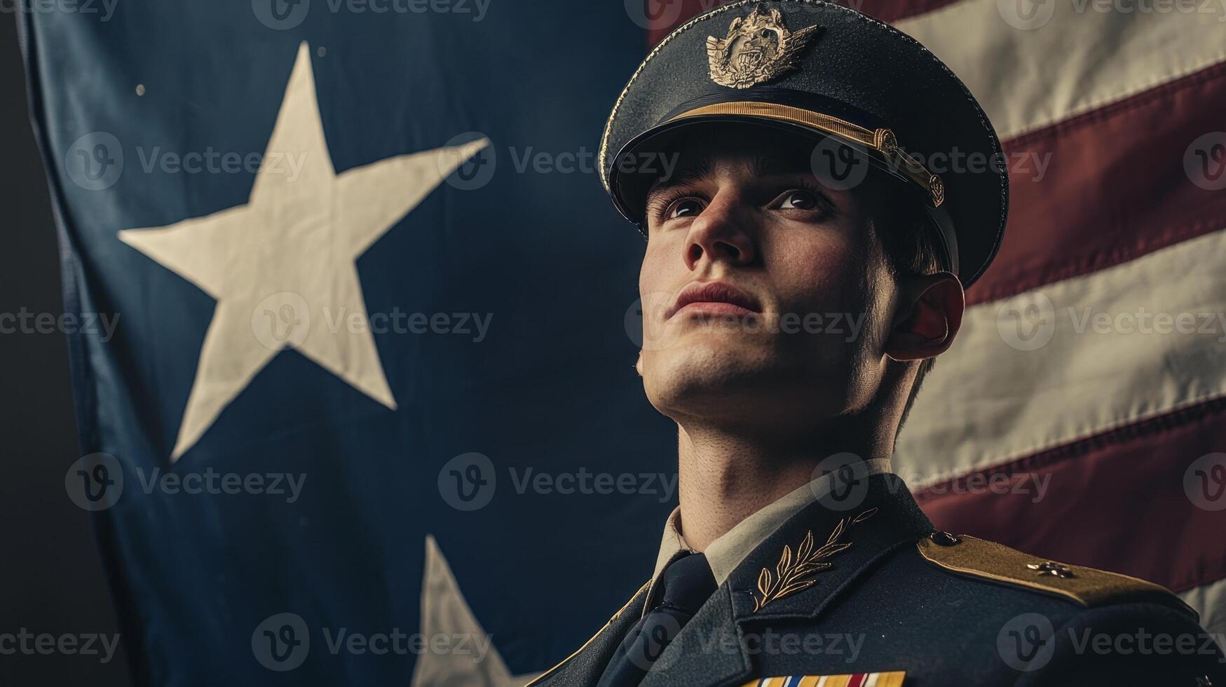 A man in uniform stands in front of an american flag photo