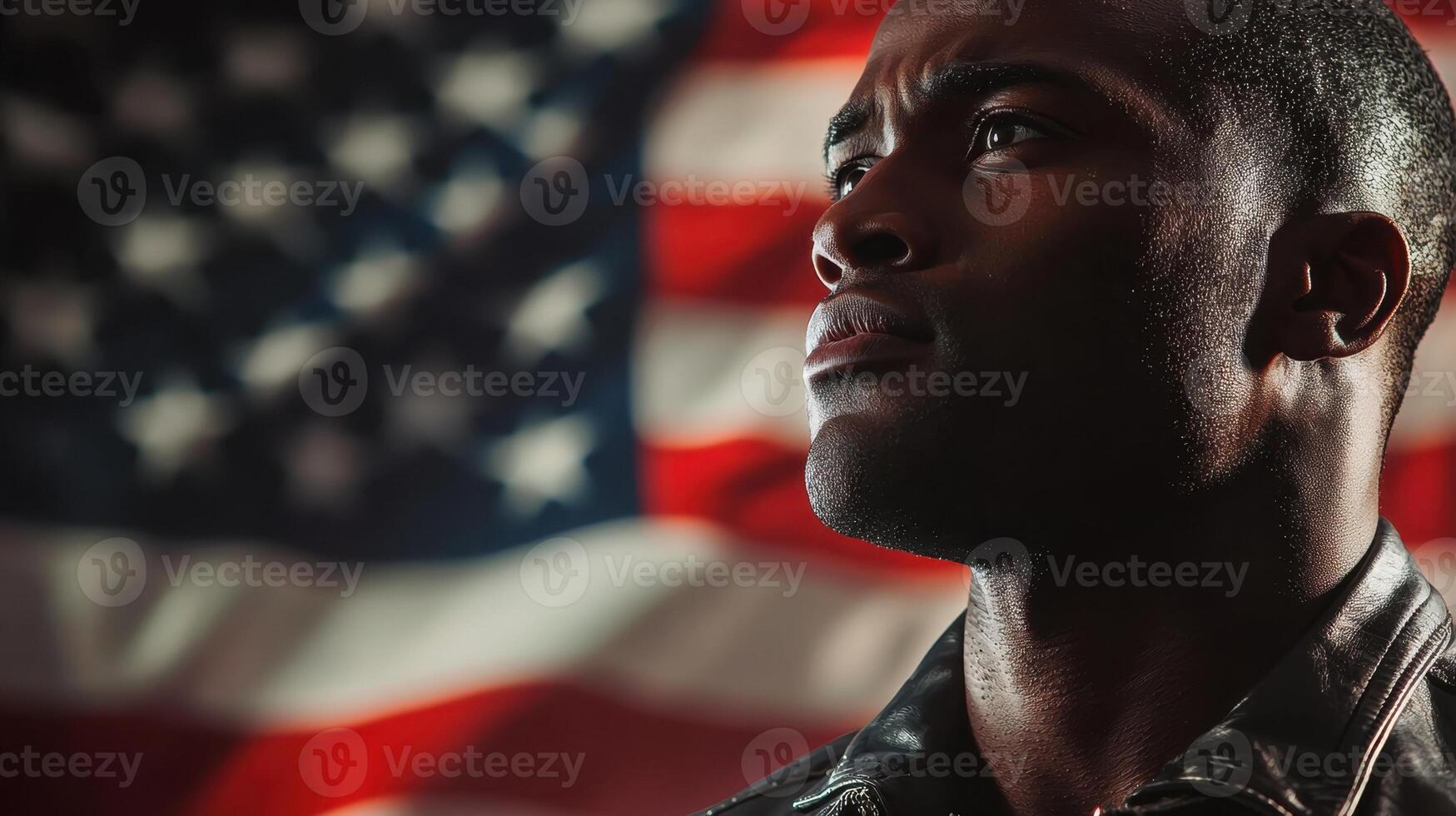 A man stands in profile, gazing thoughtfully upwards, with an American flag prominently displayed in the background, evoking feelings of pride and reflection photo