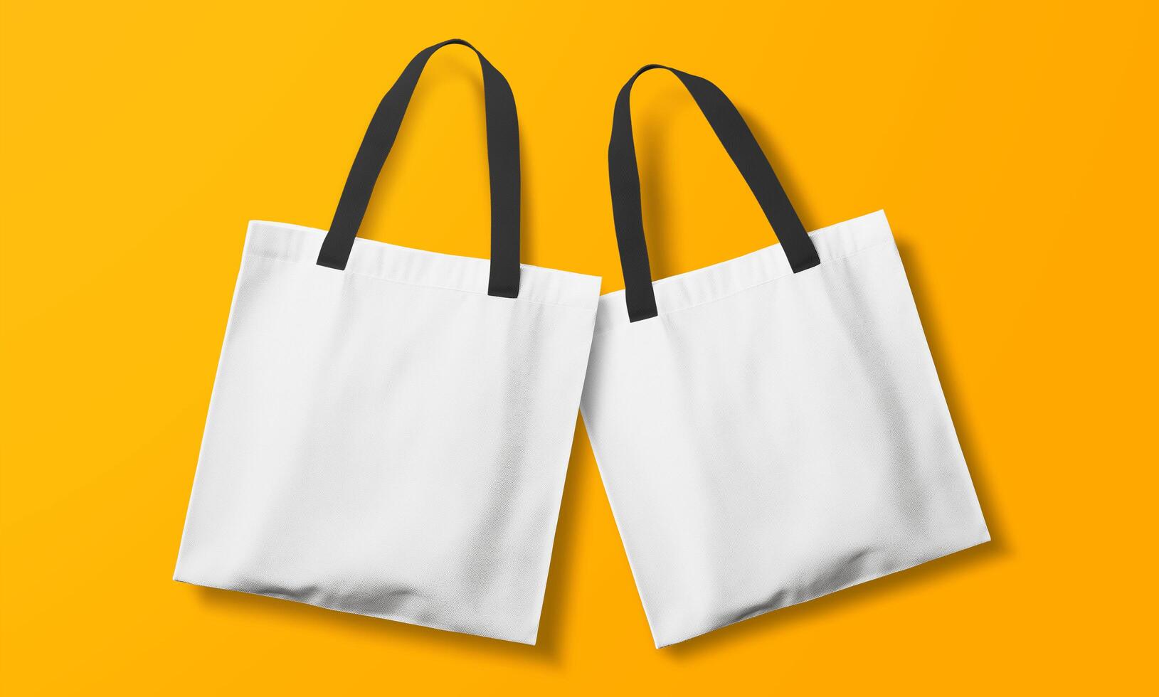 Two white shopping bags on a yellow background photo