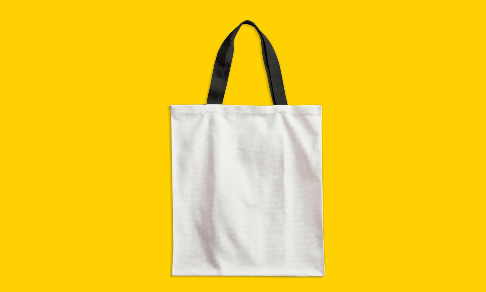 A white tote bag on a yellow background photo