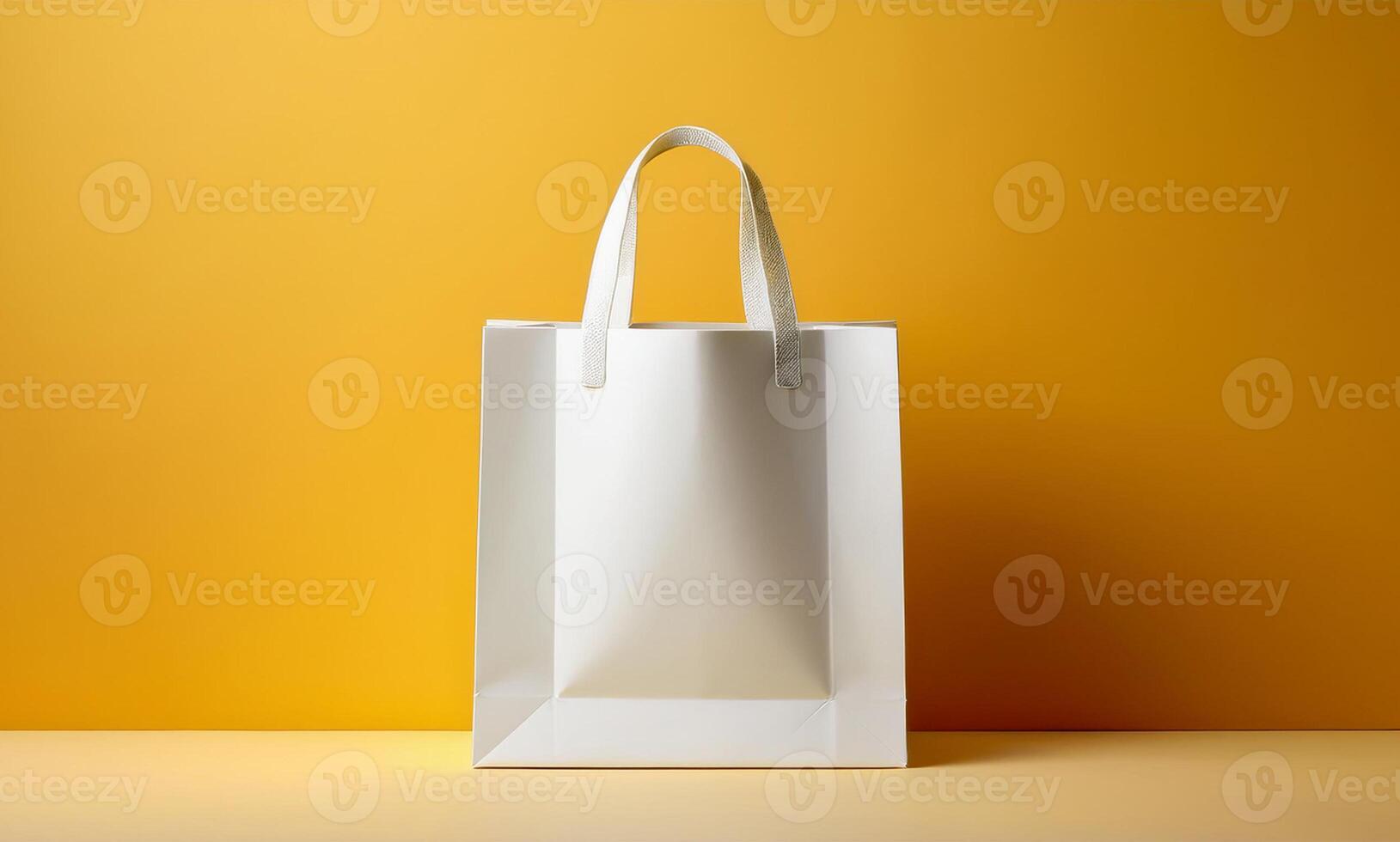 White shopping bag on yellow background photo