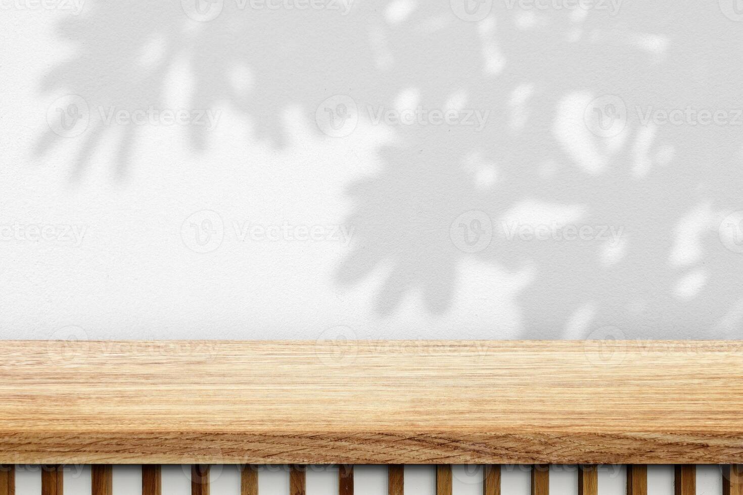 Empty Japandi Wood Table with Leaves Shadow on White Stucco Wall Texture Background photo