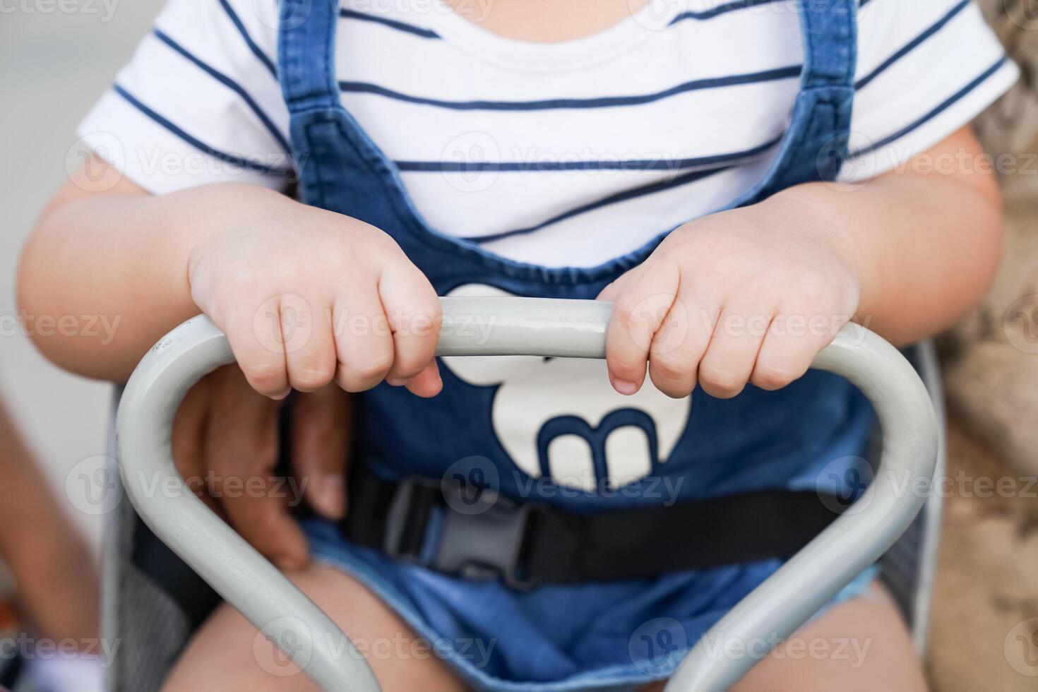 Youngster sitting on an adult bike and gripping the handle photo