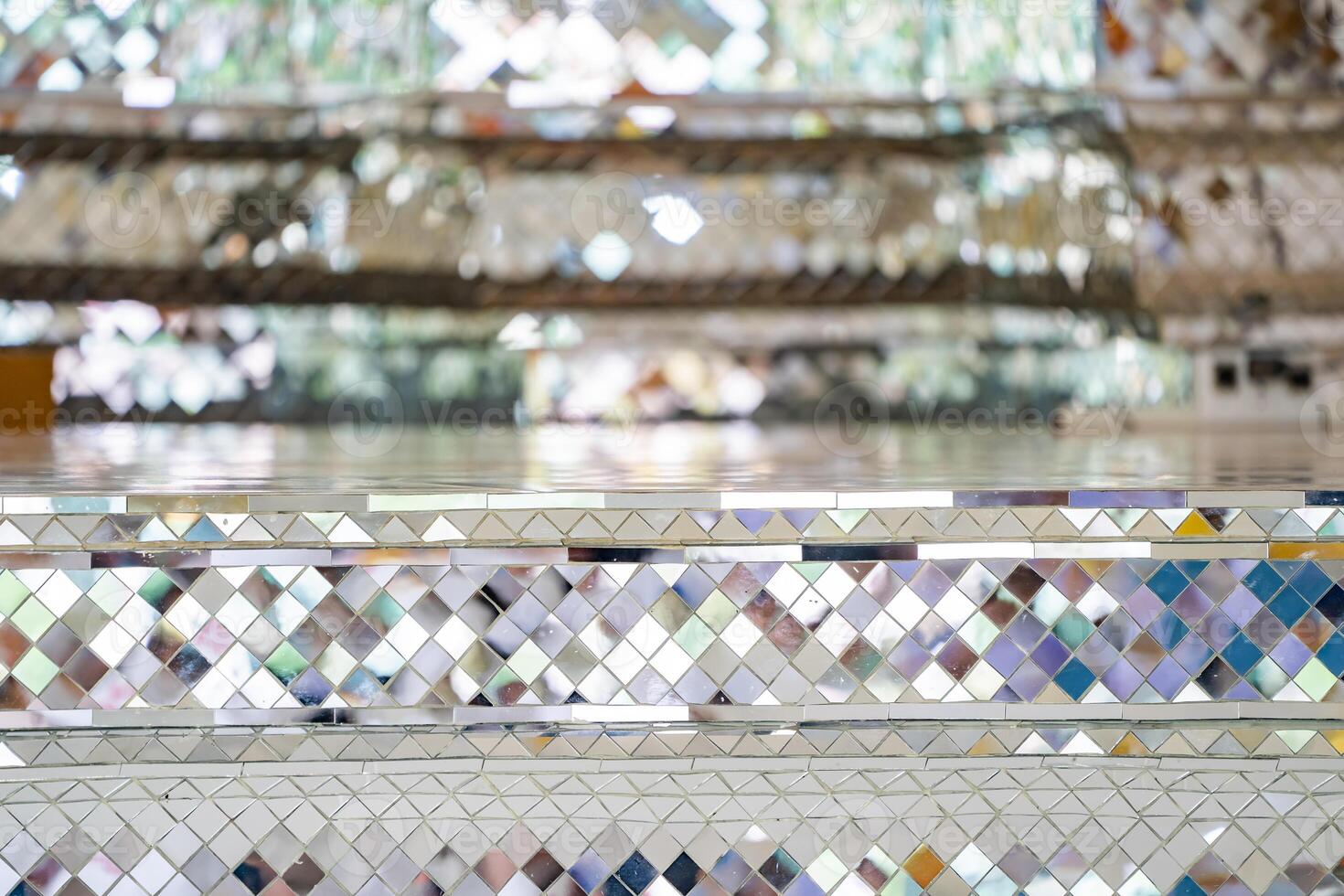 Buddhist Temple pillars and bas of pillars are decorated with Mosaic mirror. Traditional Thai temple pillar decorated with beautiful mosaic pattern inside the Buddhist temple. photo