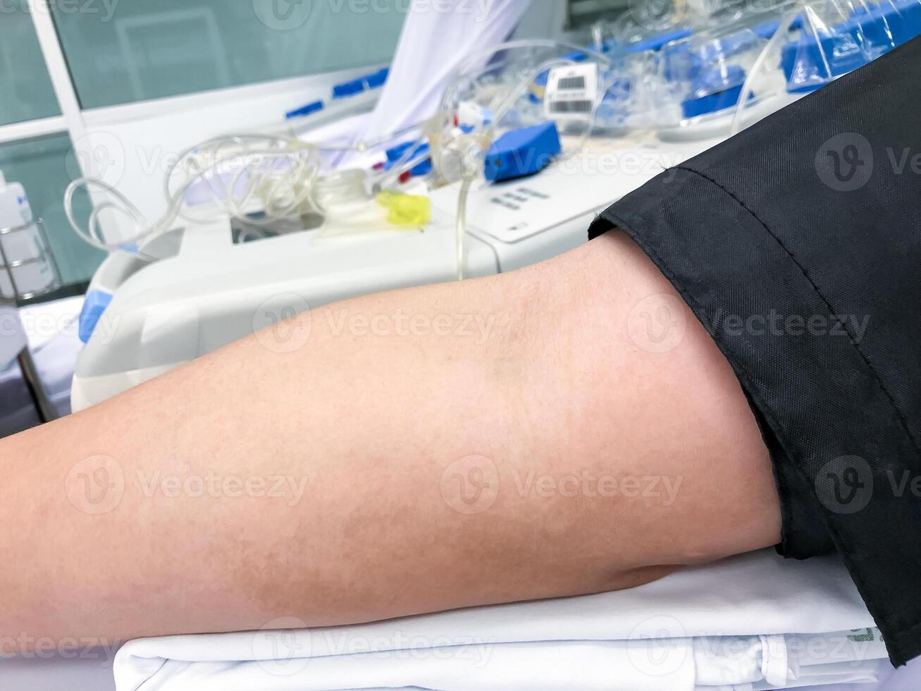 Blood platelet donation, a male nurse inserts a needle into donor s arm to draw blood photo
