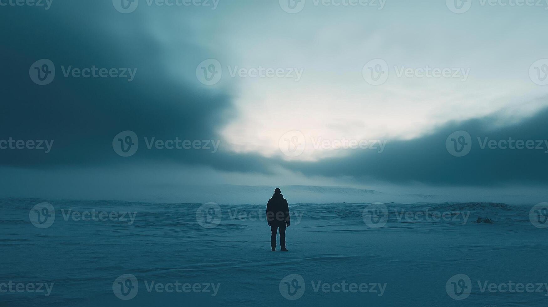 A person standing in the middle of a snowy field photo