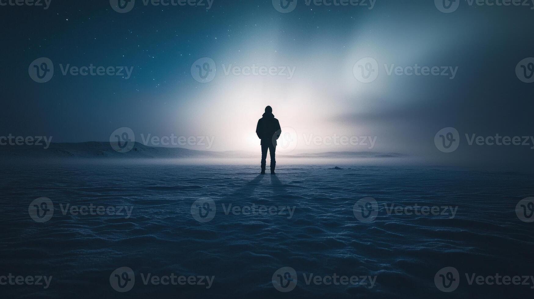 A person standing in the middle of a snowy field photo