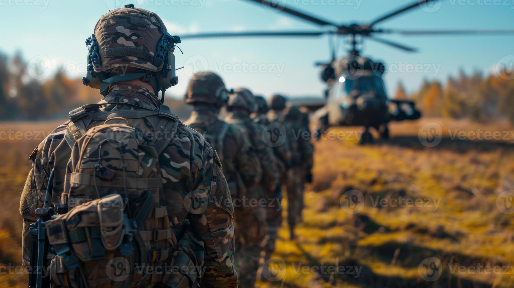 Soldiers line up in formation near a military helicopter during a training exercise in a woodland area, showcasing teamwork and readiness in the autumn landscape. photo