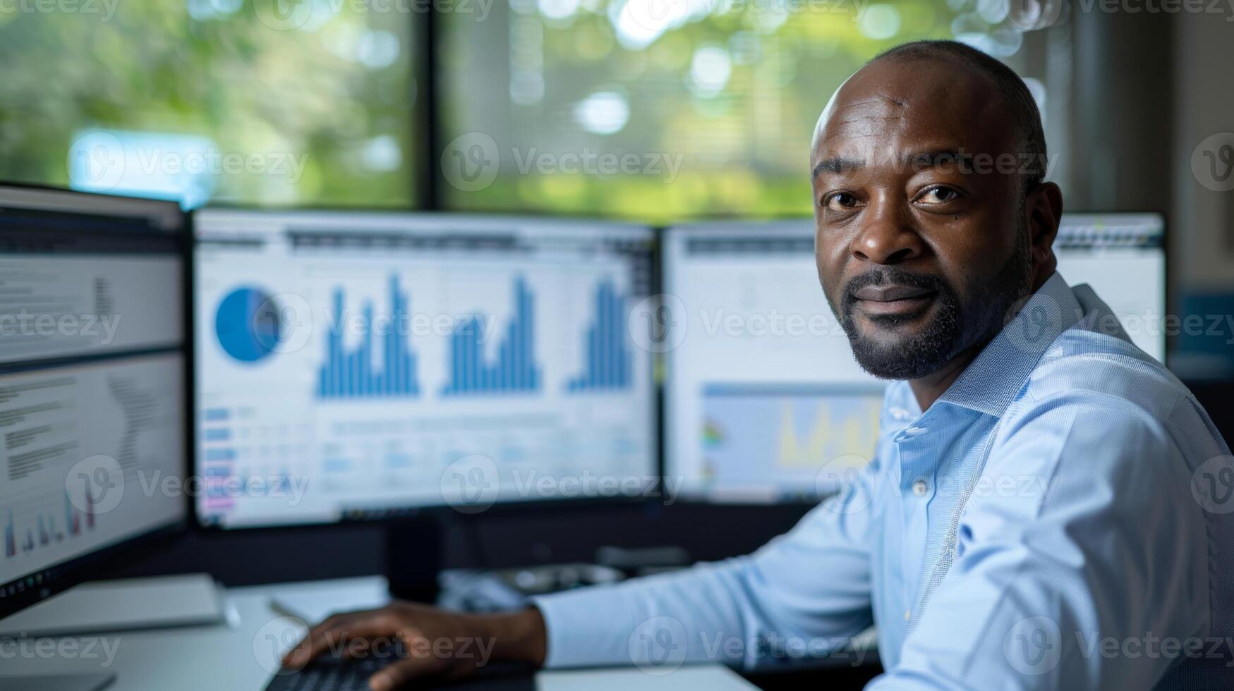 A skilled professional sits at a desk in a contemporary office, focused on analyzing data displayed on several monitors that showcase various graphs and charts. photo