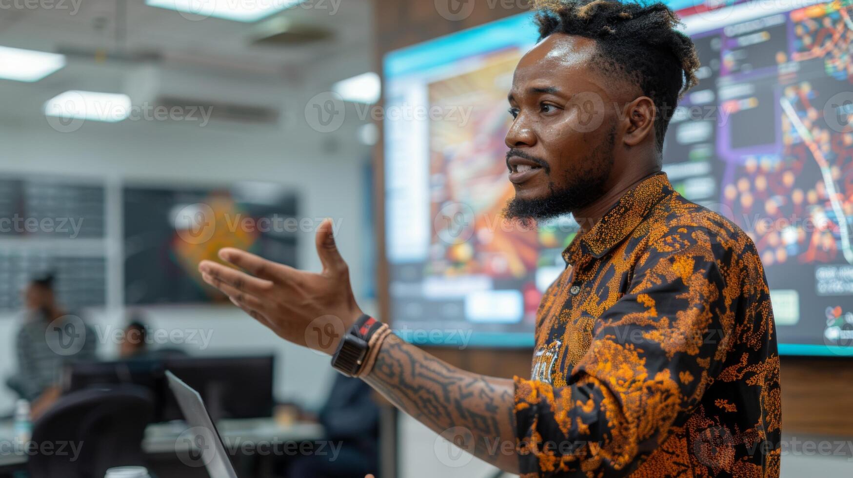 A speaker passionately discusses topics in a contemporary office, interactive screens displaying data and visuals in the background, while the audience attentively listens. photo