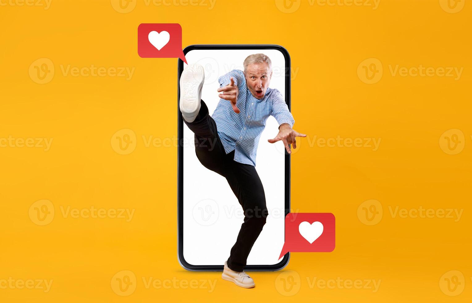A man enthusiastically interacts with a smartphone, using social media to express love and excitement. The background is vibrant yellow, emphasizing the theme of connection and technology. photo