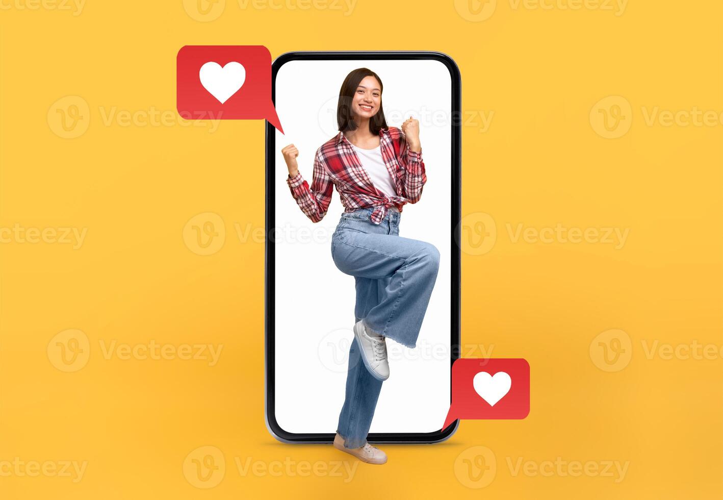 A young woman stands within a smartphone, celebrating love with positive energy. Text messages and hearts symbolize the excitement of social media interactions, ideal for Valentine's Day. photo
