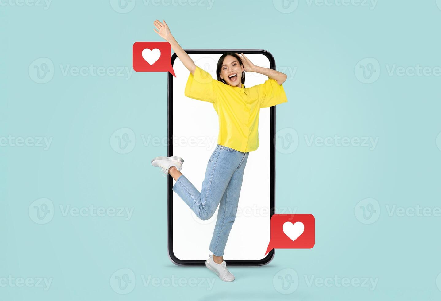 A young woman joyfully interacts with her smartphone, expressing excitement and engagement in social media. Bright colors enhance the theme of love and connection, perfect for Valentine's Day. photo