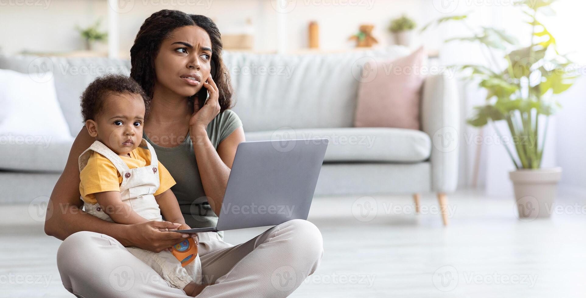 Busy Woman With Baby On Laps Using Laptop And Cellphone At Home, Young African American Mother Working Remotely With Computer, Combining Online Freelance Job And Motherhood, Free Space photo