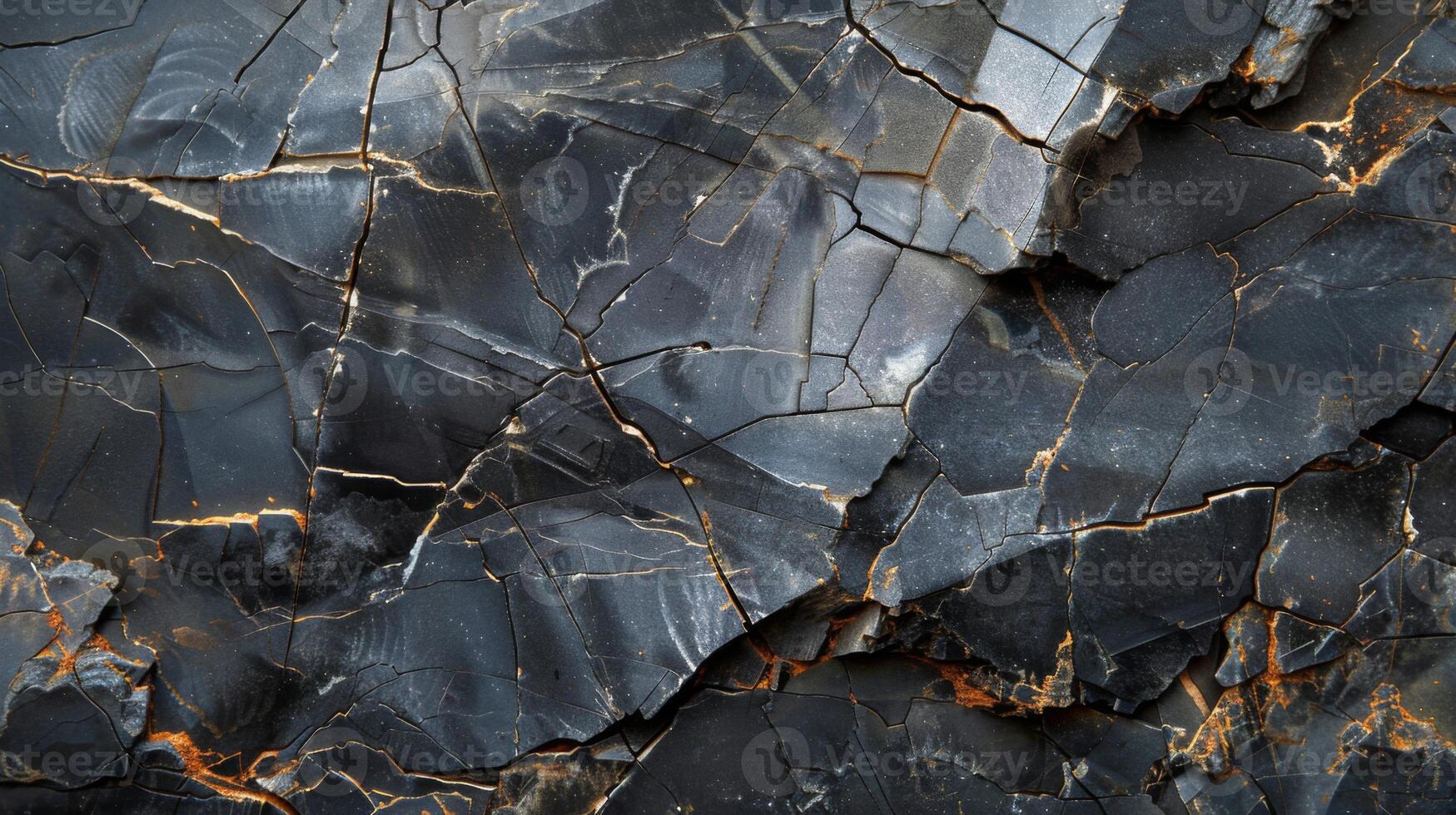 A detailed examination reveals a rugged rock surface with a network of cracks and deep color variations. photo