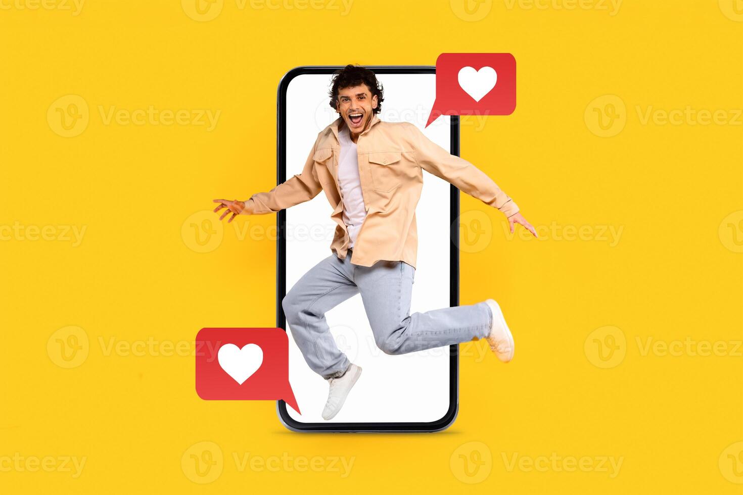 A joyful individual leaps in front of a large smartphone, surrounded by heart icons, showcasing excitement for technology and online communication related to dating and social media. photo