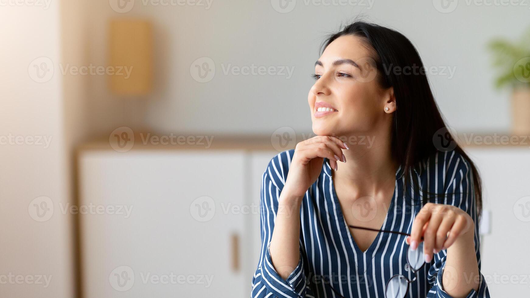 Businesswoman At Laptop Smiling Looking Aside Working Sitting In Modern Office. Dream Job Concept. Empty Space, Selective Focus photo