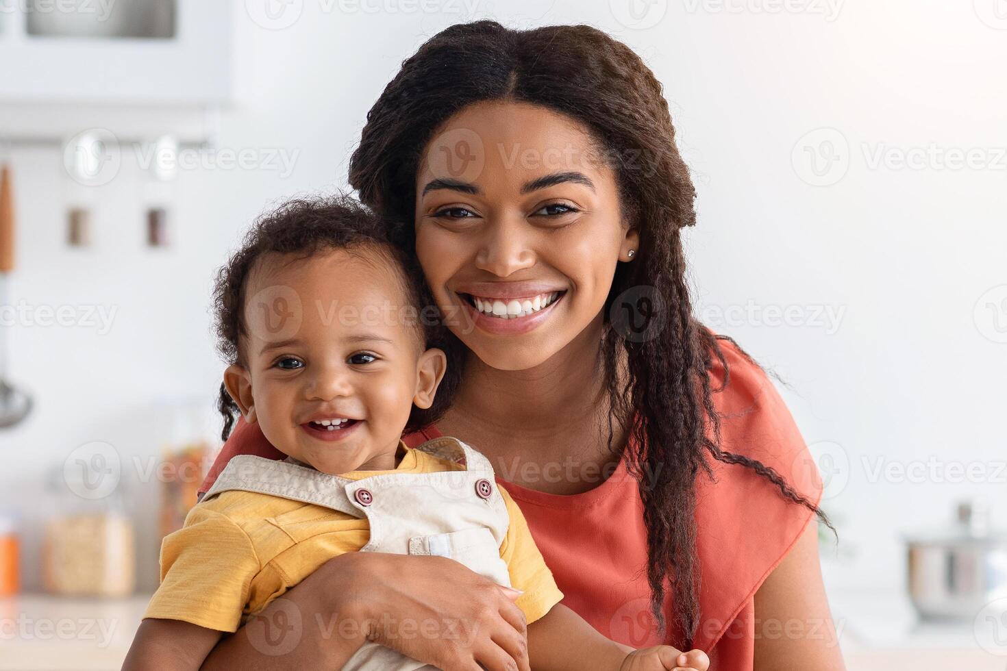 Happy Maternity Leave. Young Lady Working On Laptop Computer With Baby In Kitchen, Smiling African American Mother Combine Motherhood And Remote Freelance Work From Home, Copy Space photo