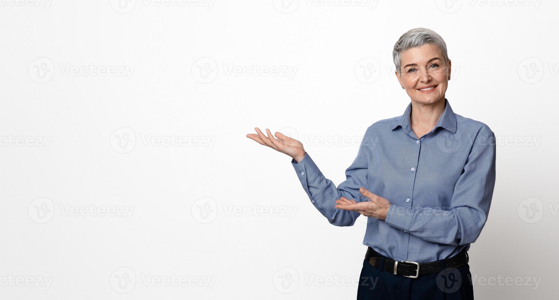 Business Ad. Confident Mature Woman Manager Pointing At Copy Space With Two Hands, Posing Over Light Studio Background, Panorama photo