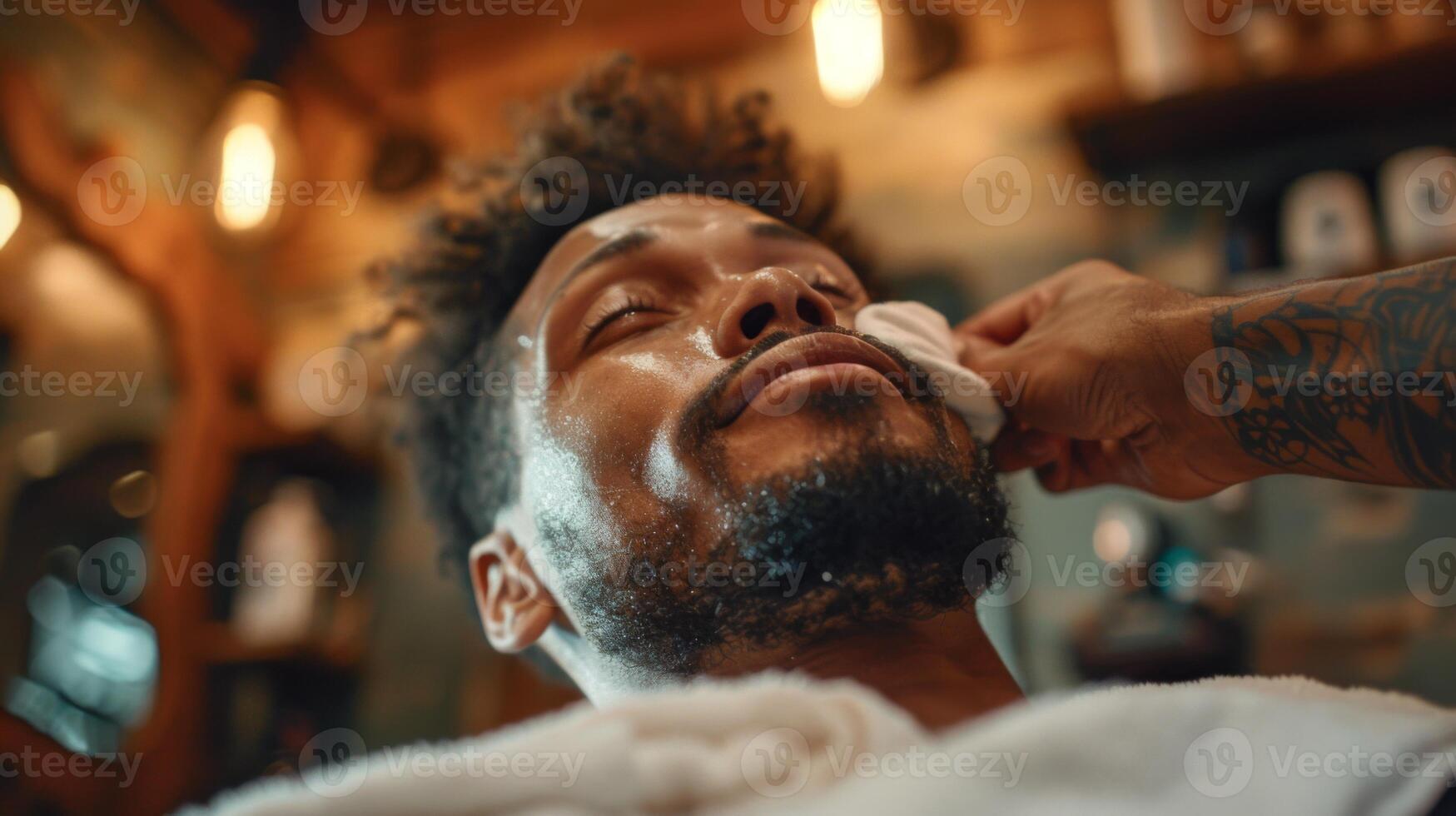 A man enjoys a facial treatment at a vintage barber shop, feeling relaxed and pampered by a skilled barber in a cozy environment filled with warm lighting. photo