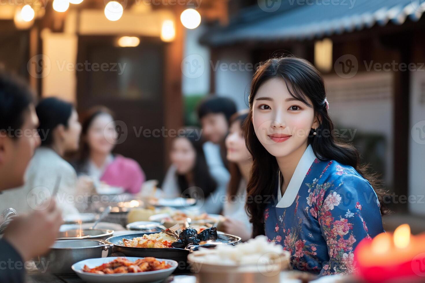 A festive gathering with people enjoying a meal outdoors. photo
