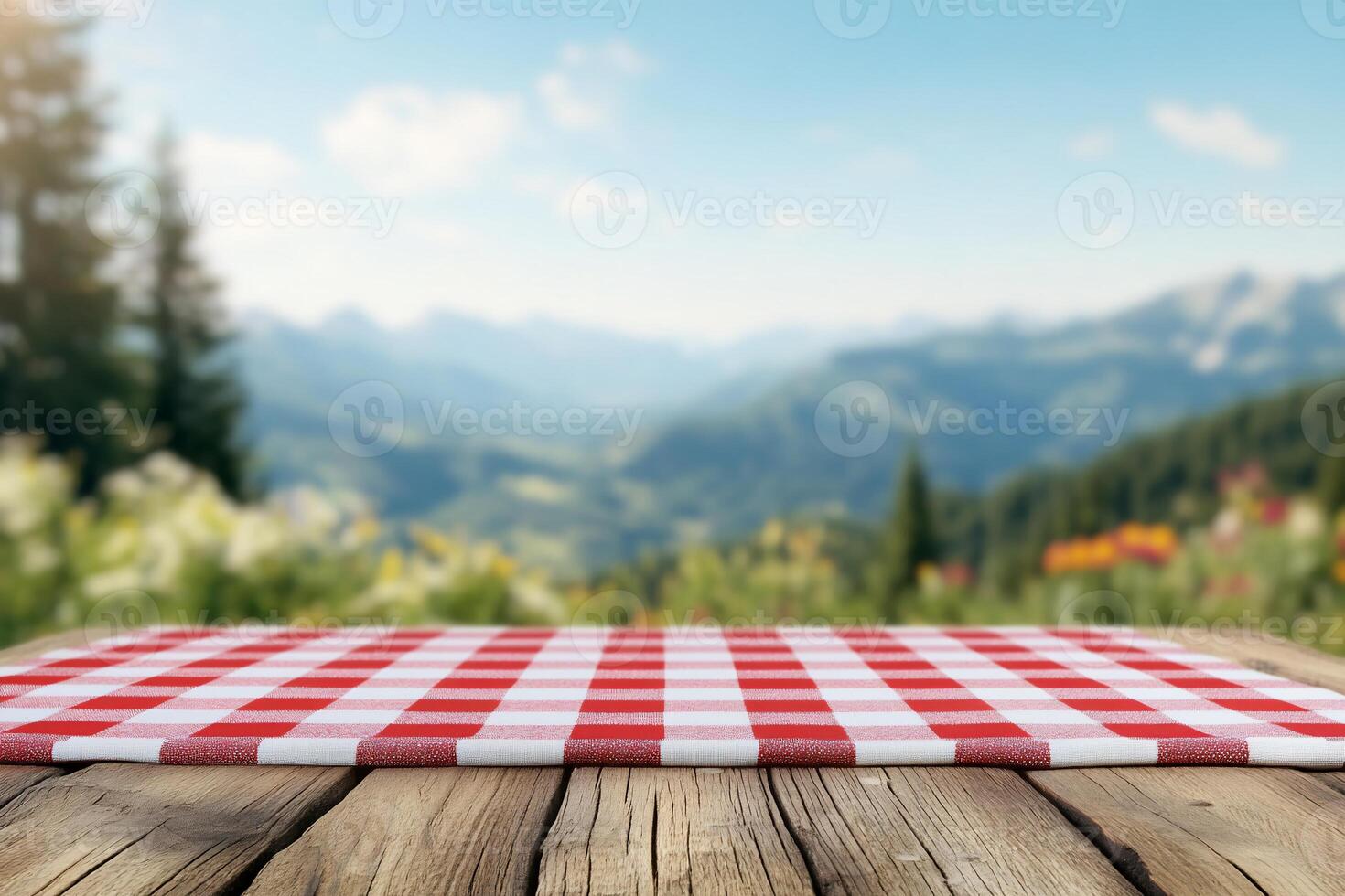 A picnic tablecloth in a scenic mountain landscape. photo