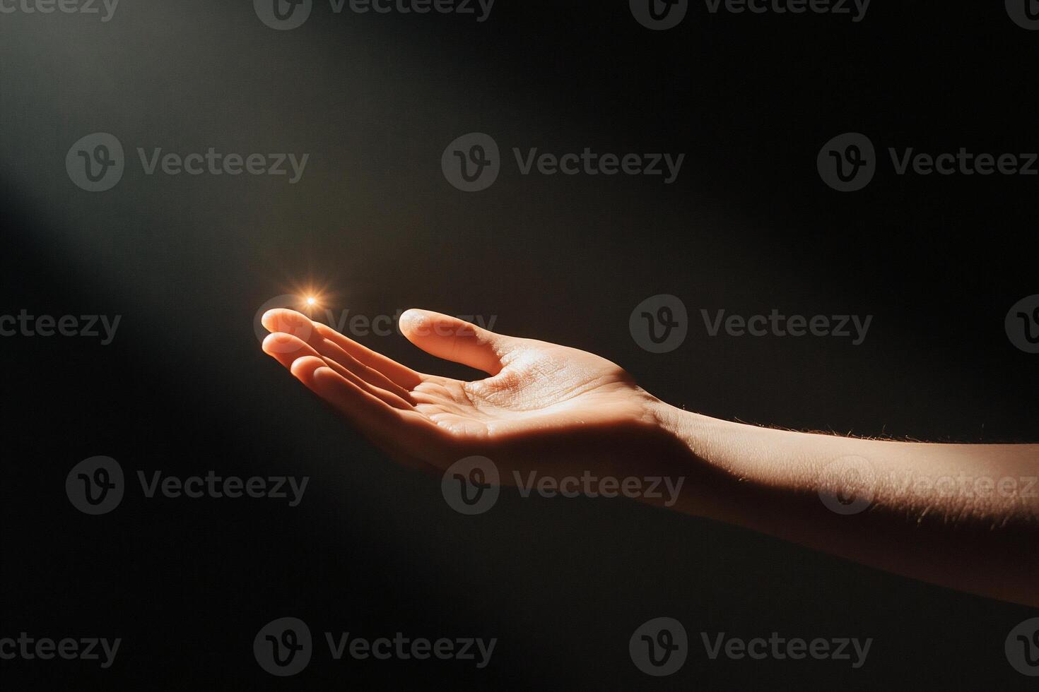 A hand reaching out with a small light, symbolizing hope or inspiration. photo