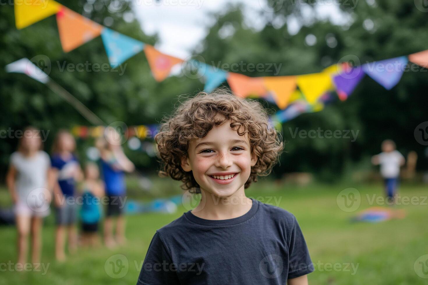 A joyful child smiles in a festive outdoor setting with colorful bunting. photo