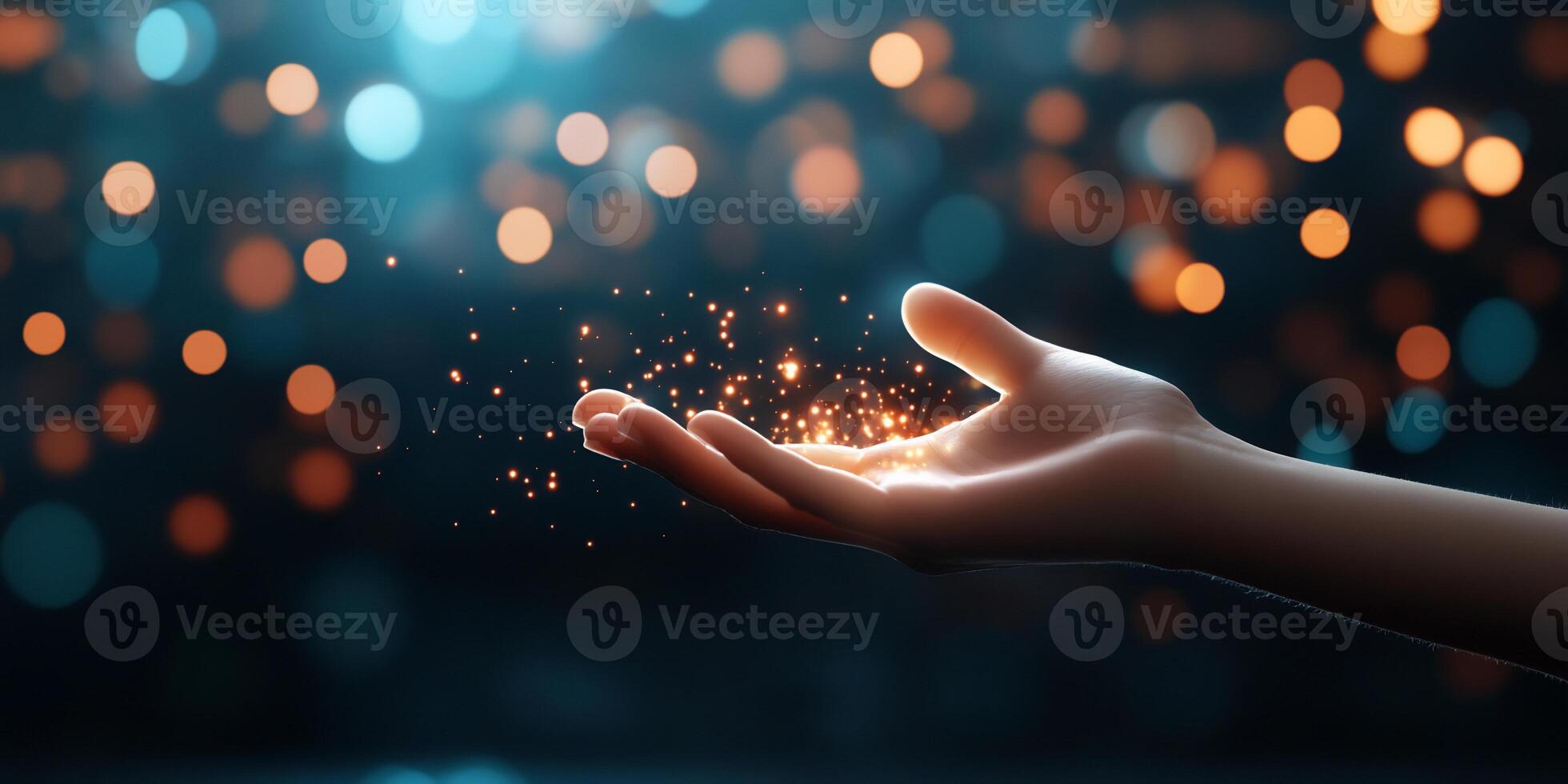 A hand releasing sparkling particles against a soft, glowing background. photo