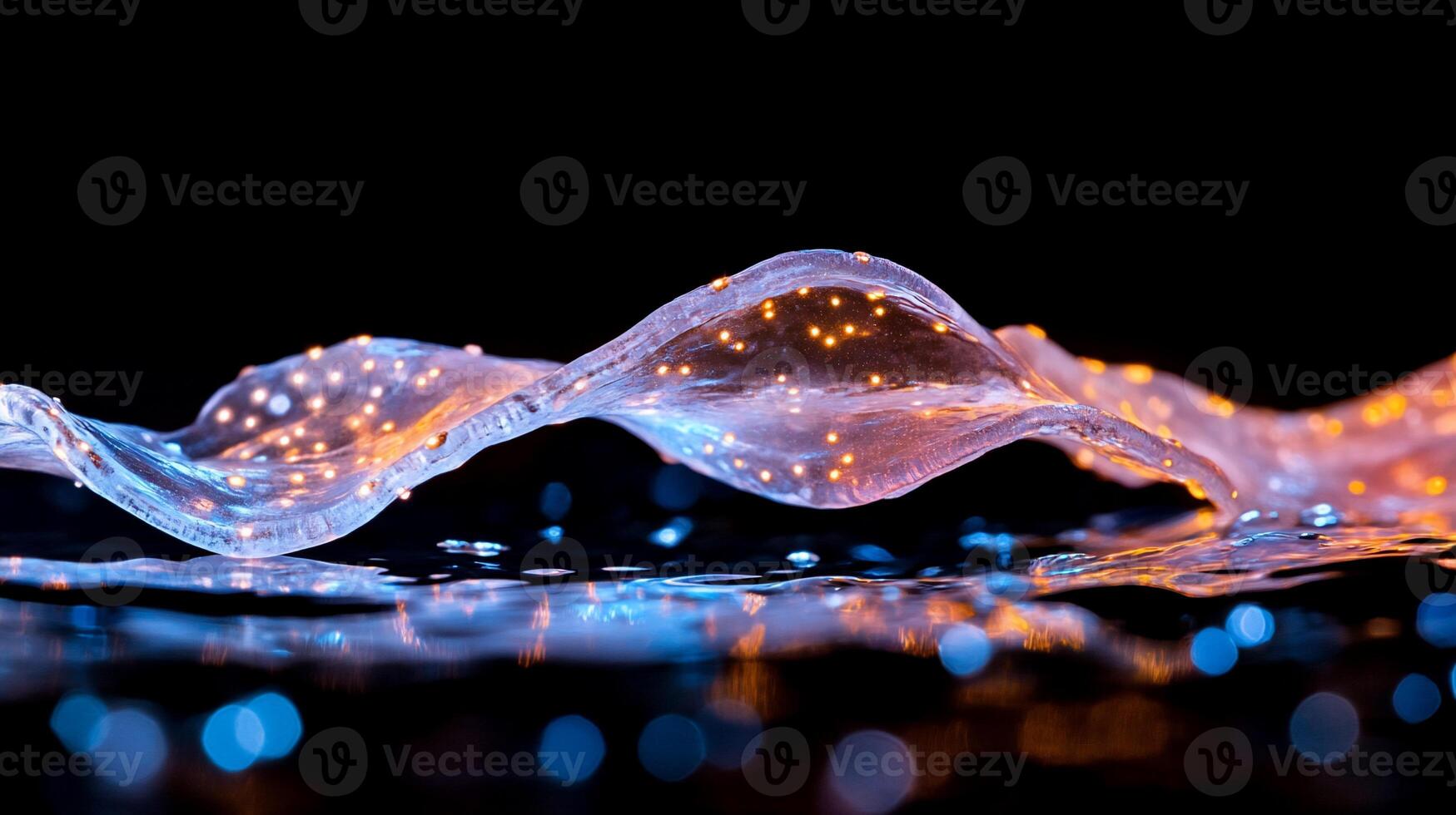 A flowing wave of light with sparkling elements against a dark background. photo