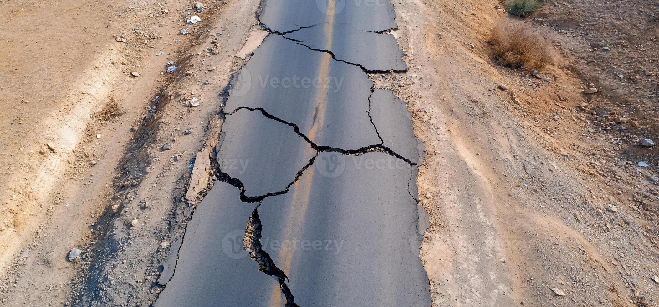 Cracked asphalt road showing signs of damage and neglect. photo