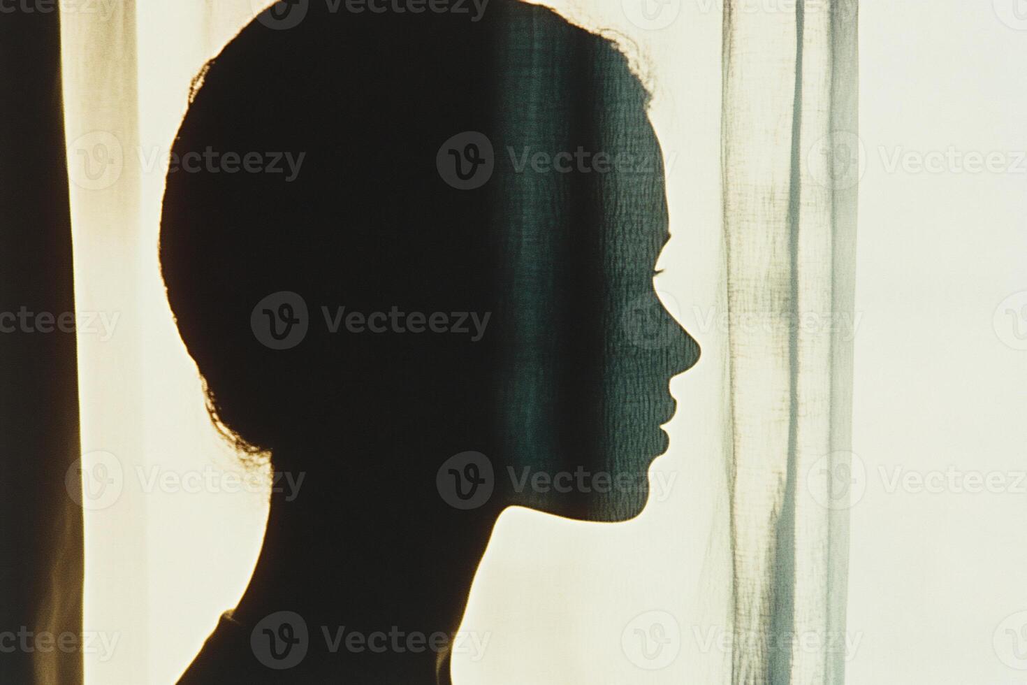 Silhouette of a woman against a light background, evoking introspection. photo