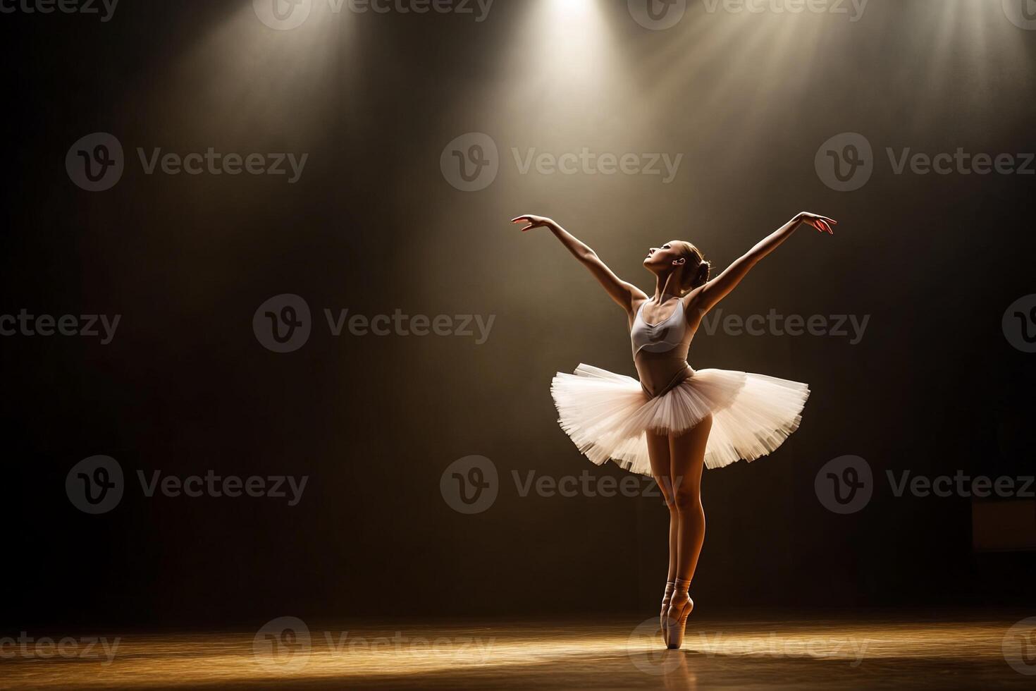 A ballerina performs gracefully on stage under spotlight. photo